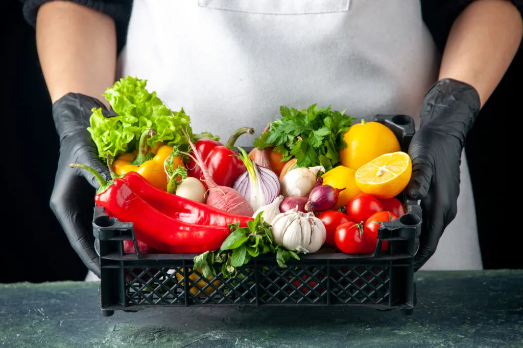 front-view-female-cook-holding-basket-with-fresh-vegetables-on-dark-food-cooking-color-salad-kitchen-cuisine-1024x683